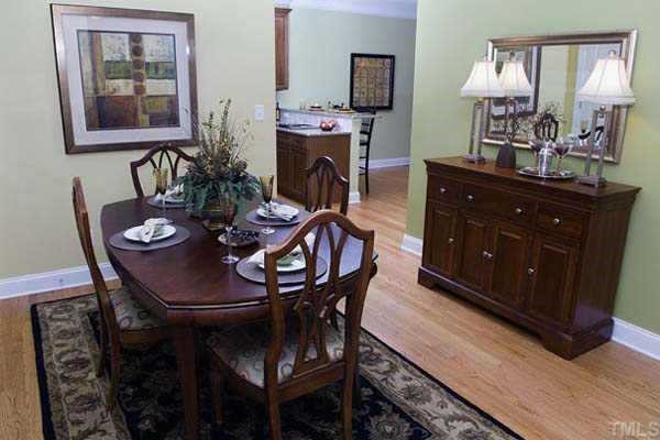 The beautiful dining room offers a hardwood floor, designer neutral wall paint, painted 2-piece crown molding, upgraded overhead light, coat closet and a door to basement. Serve delightful meals in this lovely room. Other
