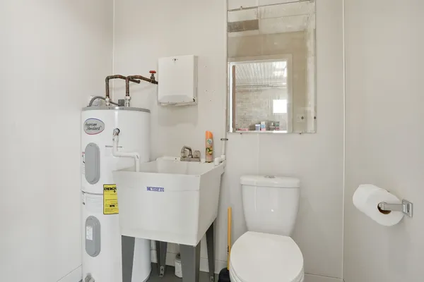 a bathroom with a sink a toilet and a mirror