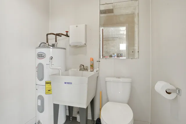 a bathroom with a sink a toilet and a mirror