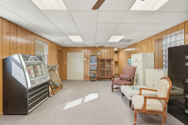 a living room with furniture gym equipment and a large window