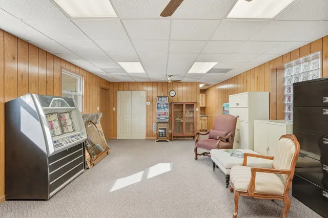 a living room with furniture gym equipment and a large window