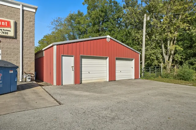 a view of a house with a yard and garage