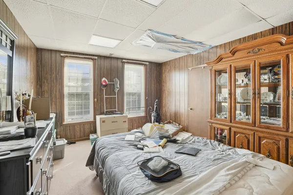 a bed sitting in a bedroom next to a large window