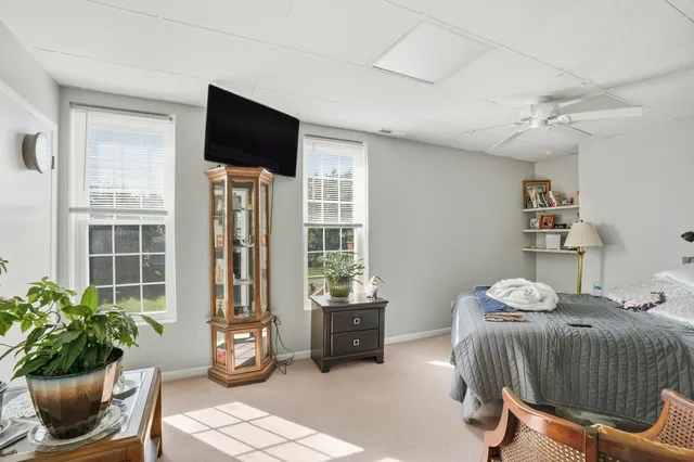 a bedroom with furniture and a flat screen tv