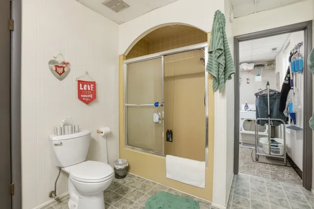 a bathroom with a toilet and a shower