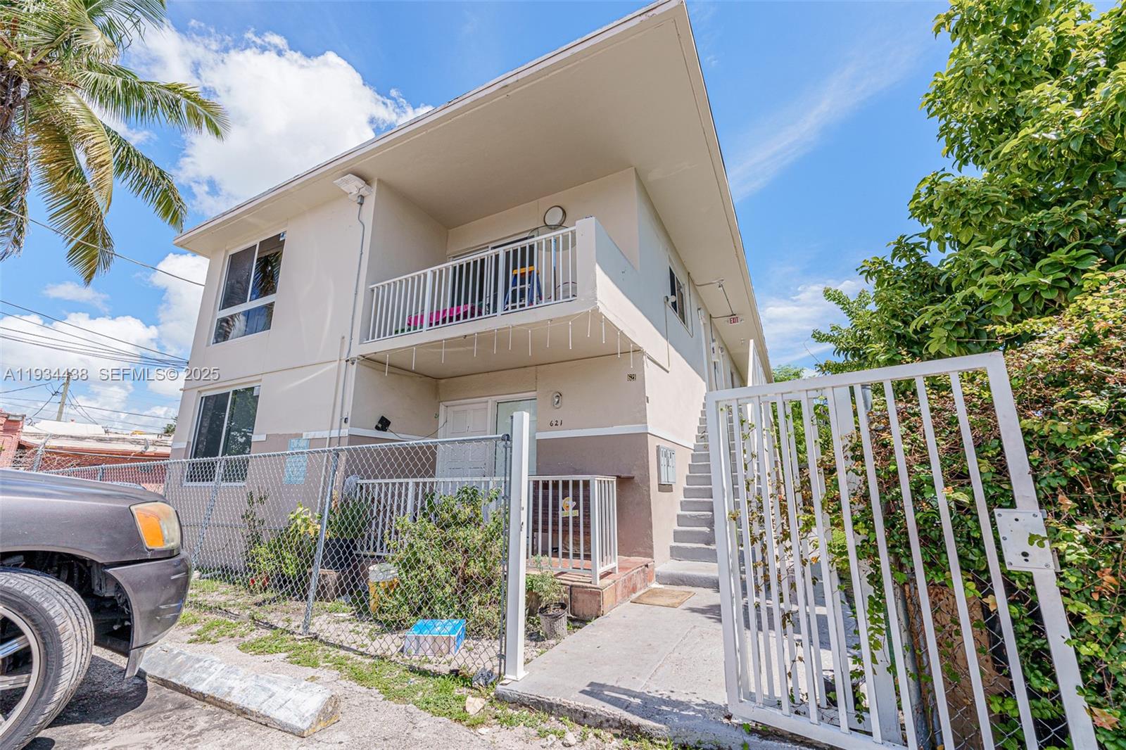 a view of a patio with a table and chairs and potted plants