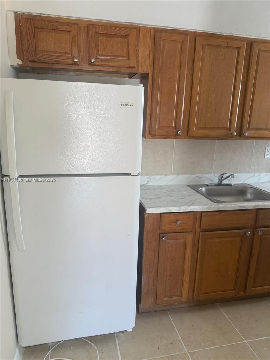 621 Southwest 15th Avenue, Unit 4 Miami, FL 33135 - Photo 4 of 15 a white refrigerator freezer sitting in a kitchen