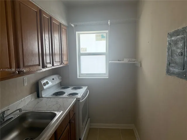 a kitchen that has a sink and a stove