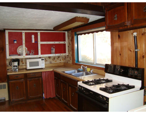 92 Gannett Road Scituate, MA 02066 - Photo 3 of 7 a kitchen with stainless steel appliances granite countertop a sink stove and cabinets