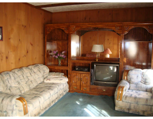 92 Gannett Road Scituate, MA 02066 - Photo 4 of 7 a living room with furniture and a fireplace