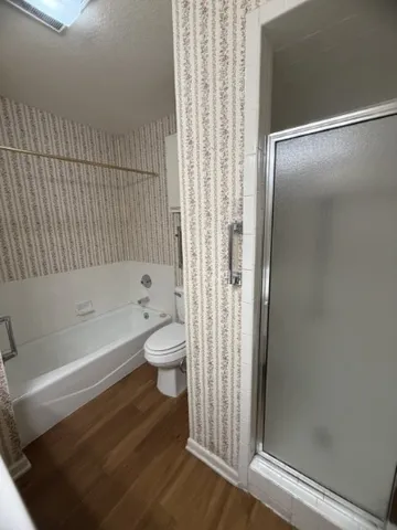 a bathroom with a bathtub and a shower