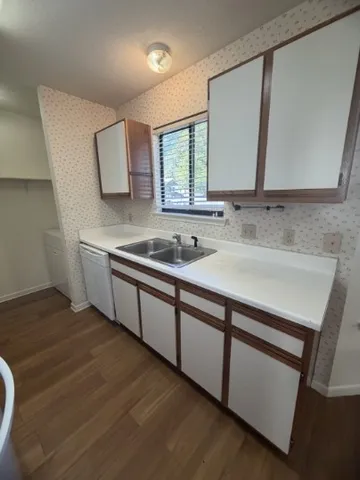 a kitchen with a sink and a stove top oven
