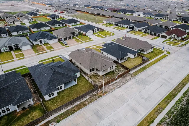 an aerial view of residential houses with outdoor space