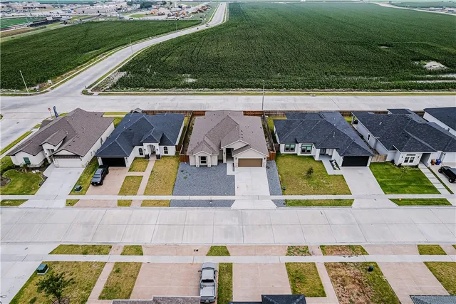 an aerial view of residential houses with yard