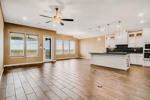 a view of kitchen with sink and window