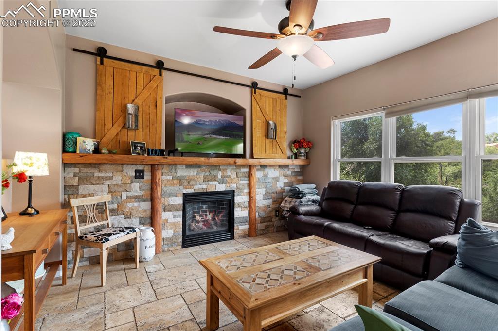 803 Ridgebury Place Fountain, CO 80817 - Photo 15 of 45 a living room with furniture a flat screen tv and a fireplace
