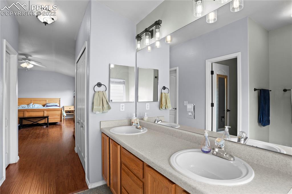 803 Ridgebury Place Fountain, CO 80817 - Photo 33 of 45 a en suite bathroom with a double vanity sink and a mirror