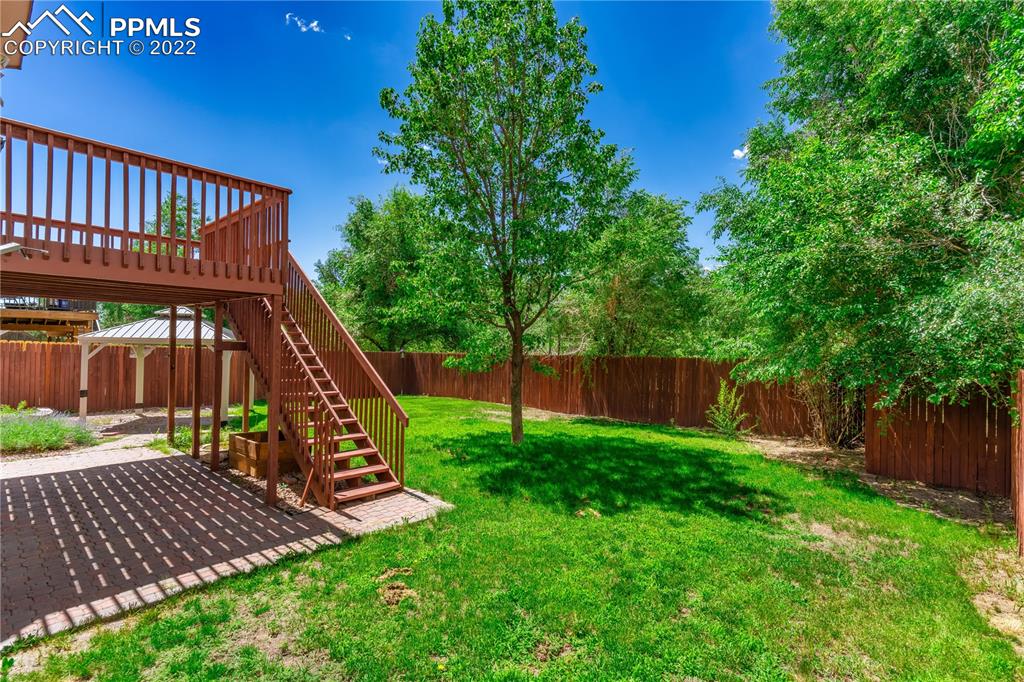 803 Ridgebury Place Fountain, CO 80817 - Photo 7 of 45 a view of a deck with a table and chairs with wooden fence