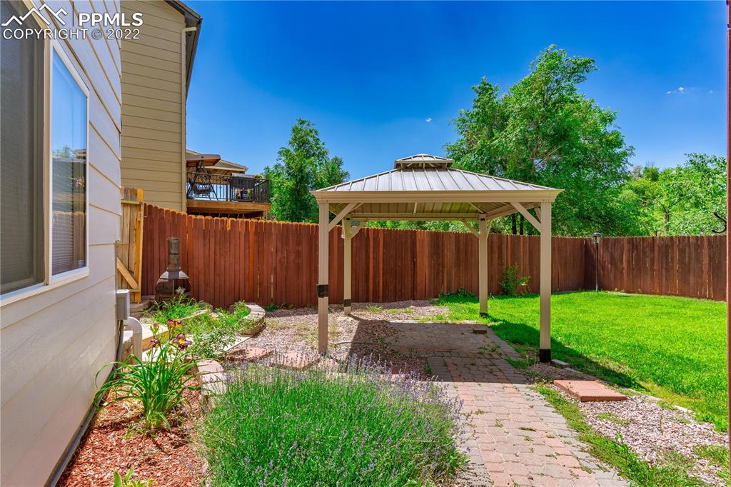 803 Ridgebury Place Fountain, CO 80817 - Photo 10 of 45 a backyard of a house with a garden