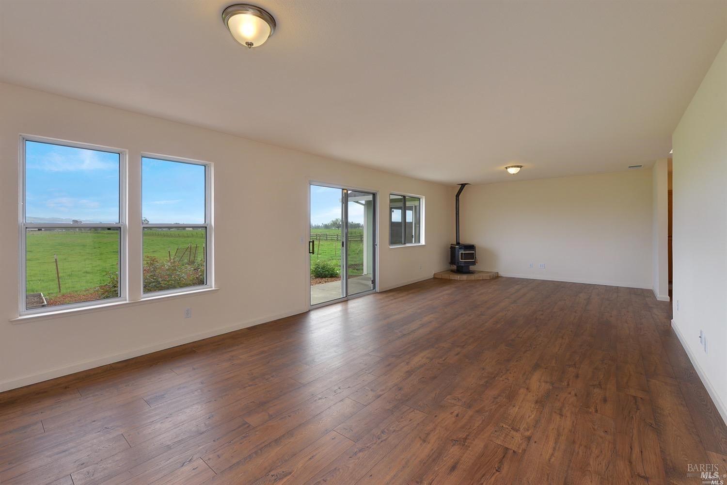 3980 Stony Point Road Santa Rosa, CA 95407 - Photo 13 of 42 an empty room with wooden floor and windows