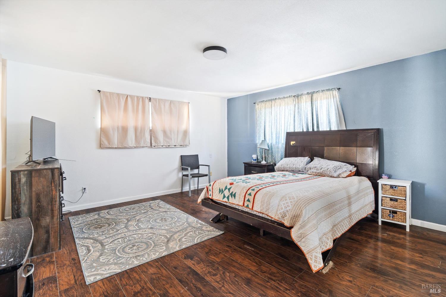 3980 Stony Point Road Santa Rosa, CA 95407 - Photo 14 of 31 a bedroom with a bed and wooden floor
