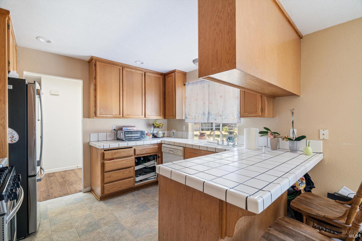 3980 Stony Point Road Santa Rosa, CA 95407 - Photo 22 of 42 a kitchen with a stove a refrigerator and a sink