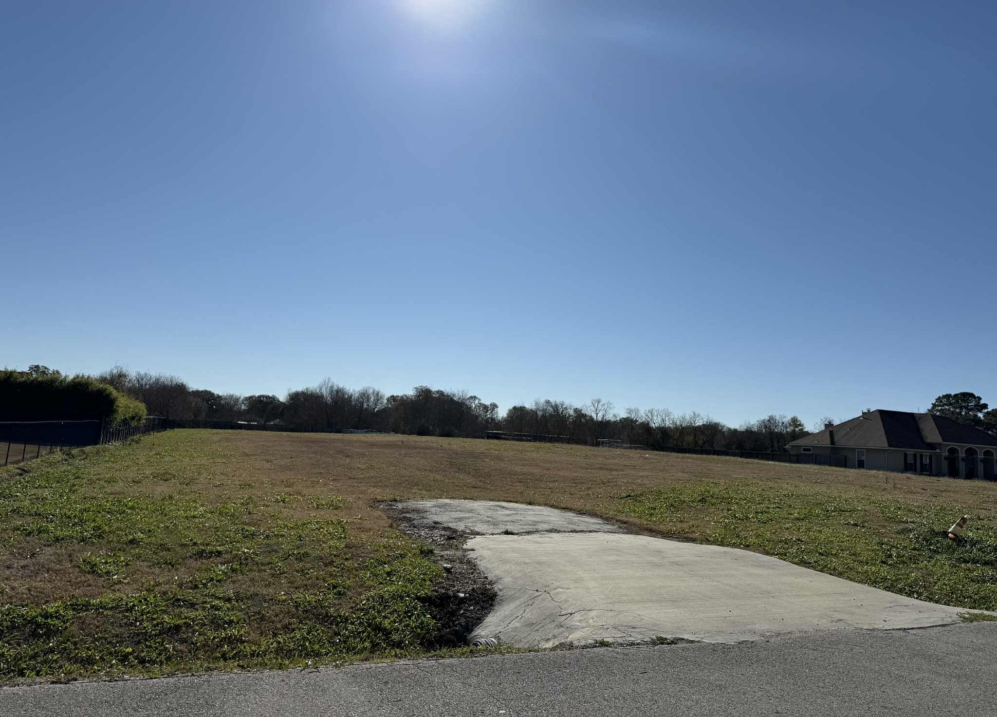 6420 Garner Street Groves, TX 77619 - Photo 2 of 3 a view of a lake in between of field and trees
