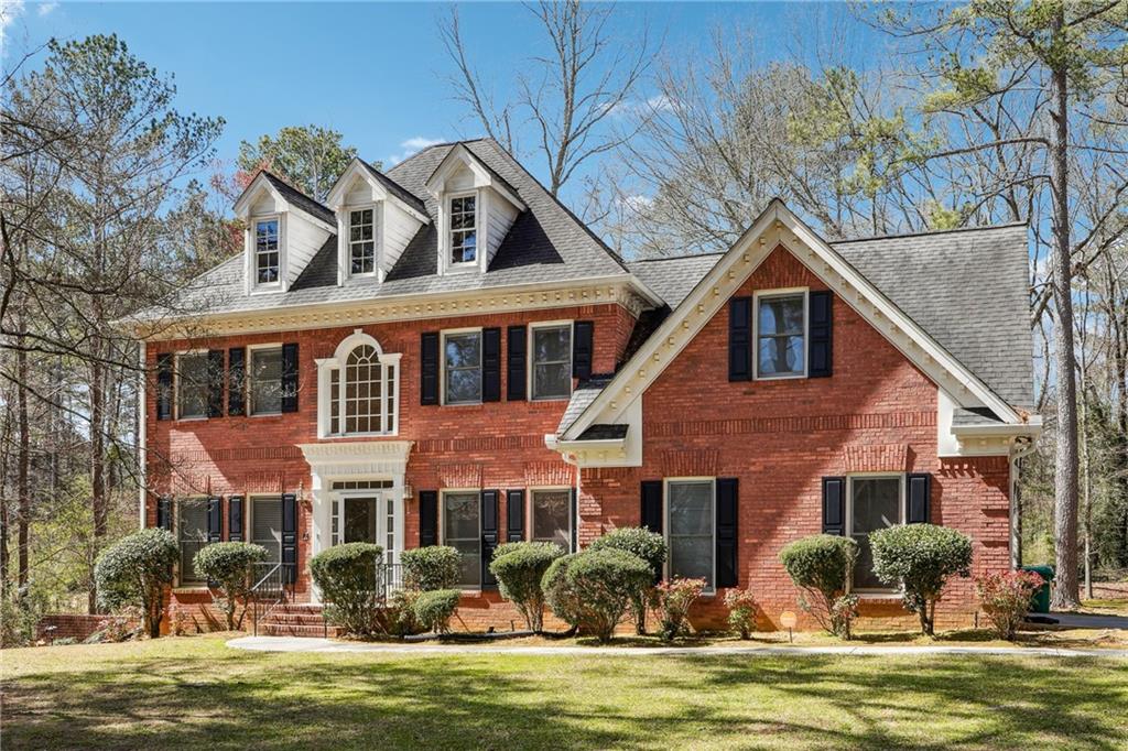 3395 Hunters Hill Drive Stonecrest, GA 30038 - Photo 1 of 1 a front view of a house with a garden