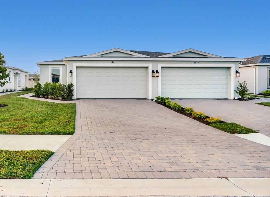 16126 Ivy Ridge Port Charlotte, FL 33953 - Photo 1 of 1 a front view of a house with a yard and garage