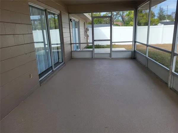 a view of an empty room with large windows