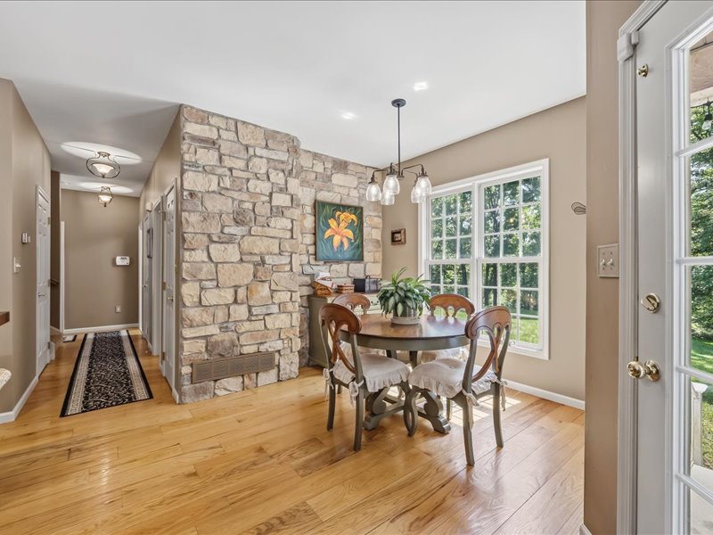 1168 Mt Pleasant Road Bangor, PA 18013 - Photo 37 of 100 Warm hardwood floors complement a textured stone accent wall in this inviting dining space.