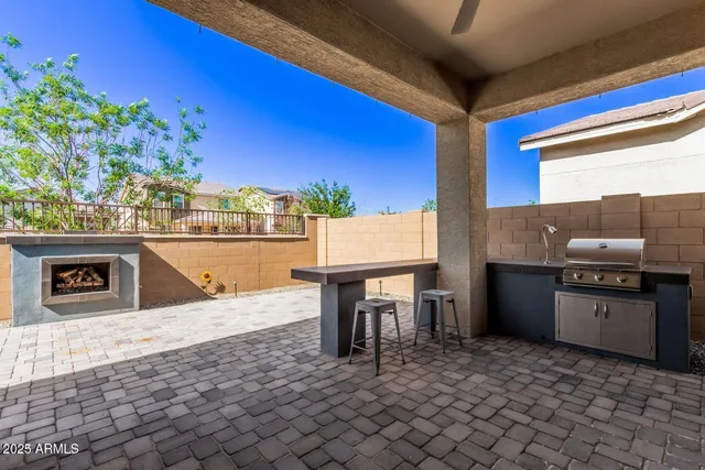 a kitchen with a sink a stove and chairs
