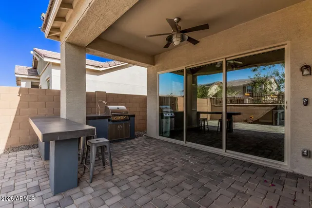a view of a porch with a table and chairs