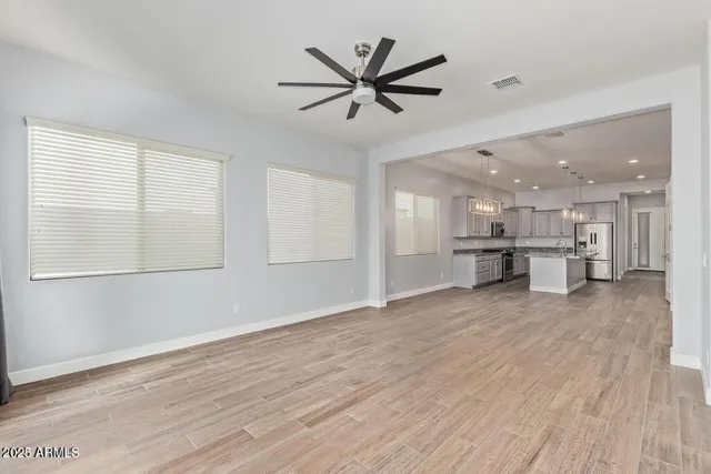 a view of a livingroom with a hardwood floor and a ceiling fan