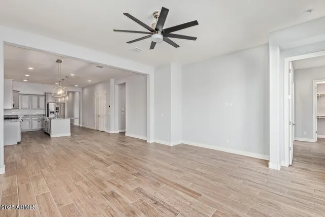 a view of an empty room with a ceiling fan