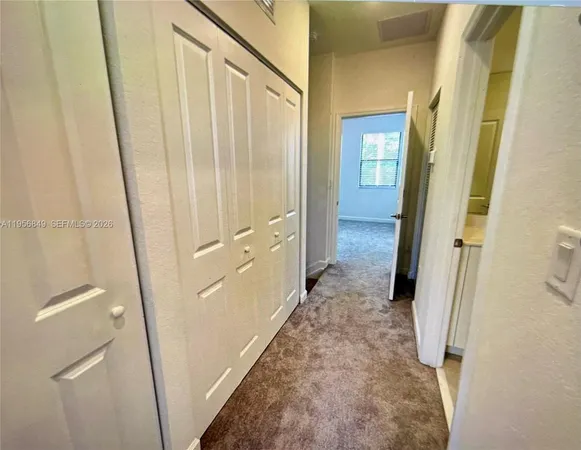 a view of a bathroom from a corridor