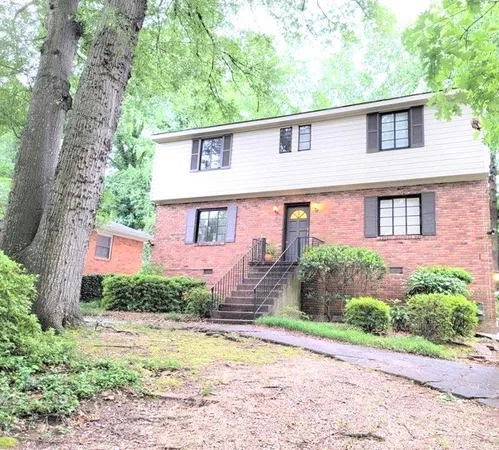 a front view of a house with a yard and a garage