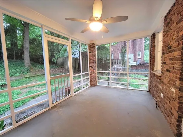 a view of a porch with a floor to ceiling window and yard