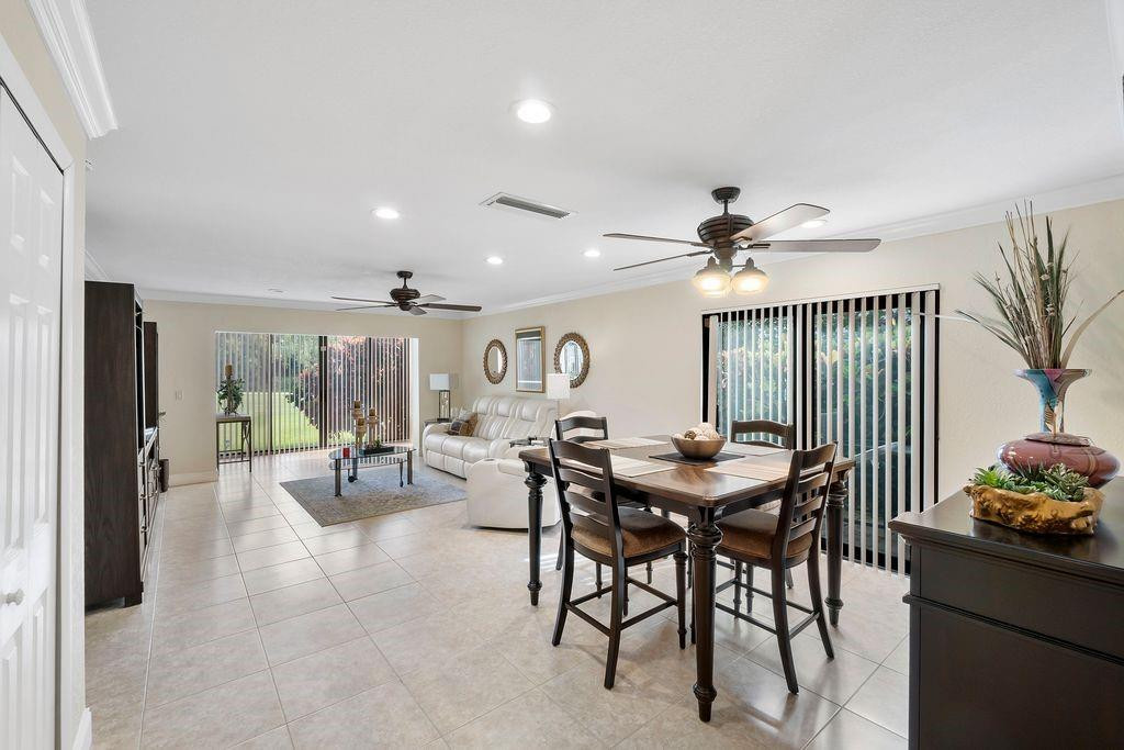 21452 Juego Circle, Unit 31A Boca Raton, FL 33433 - Photo 15 of 38 a view of a dining room with furniture and chandelier