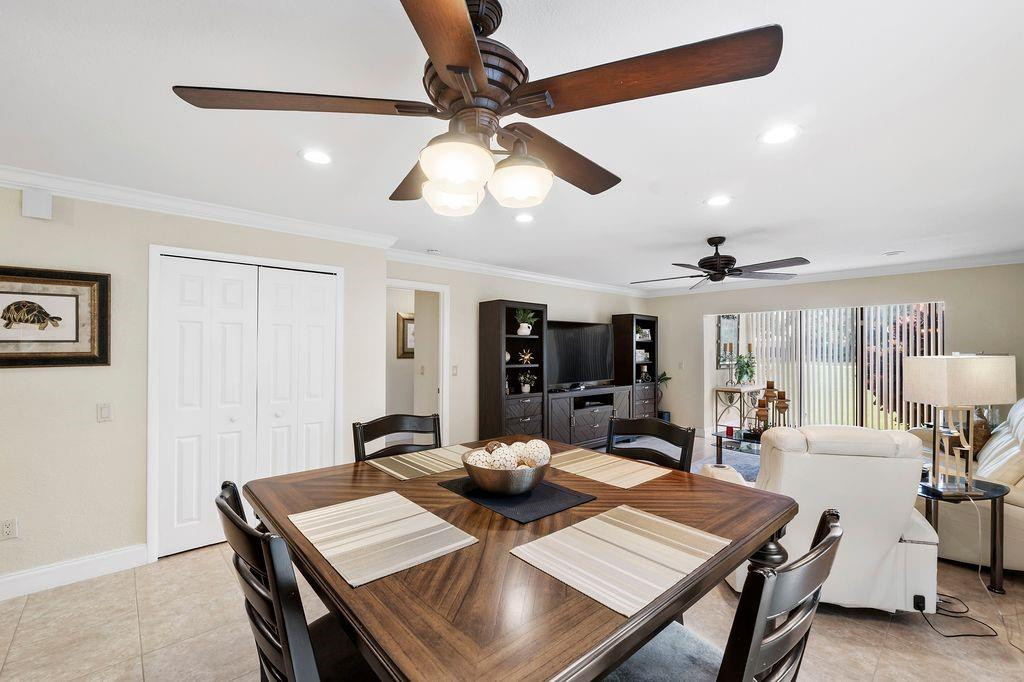 21452 Juego Circle, Unit 31A Boca Raton, FL 33433 - Photo 16 of 38 a view of a dining room with furniture and a chandelier