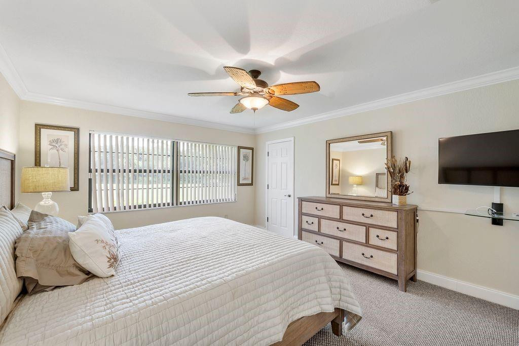 21452 Juego Circle, Unit 31A Boca Raton, FL 33433 - Photo 21 of 38 a bedroom with a bed and a flat screen tv