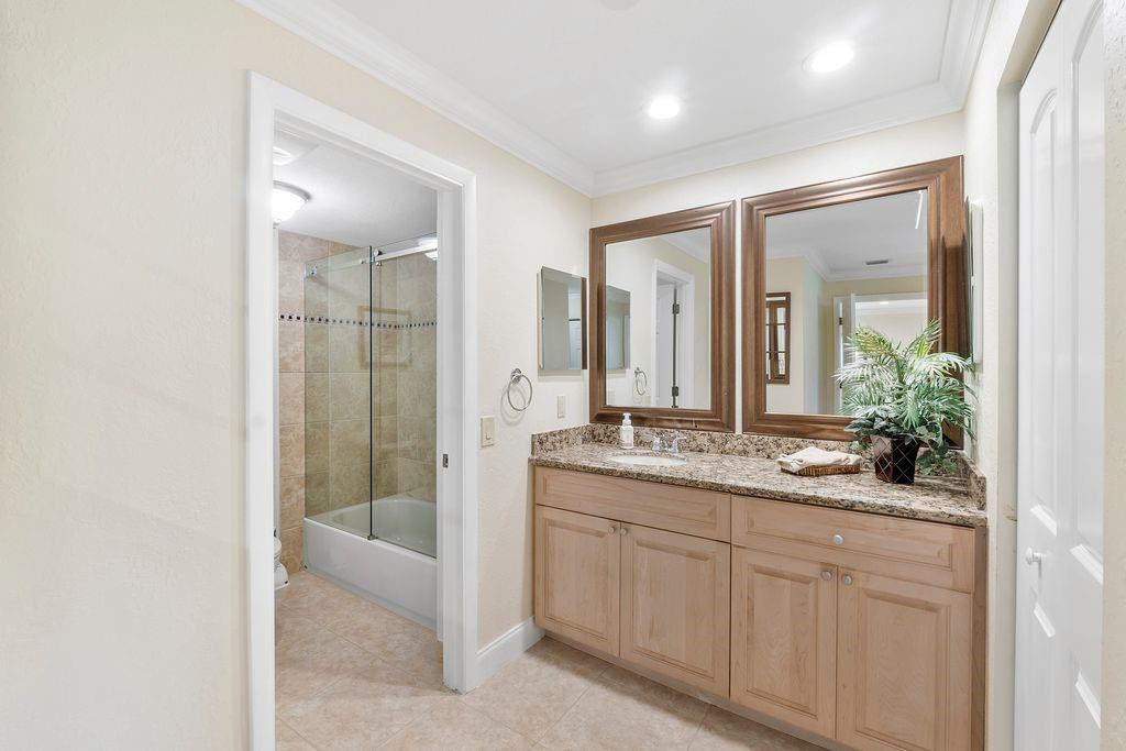 21452 Juego Circle, Unit 31A Boca Raton, FL 33433 - Photo 23 of 38 a bathroom with a granite countertop sink mirror and double