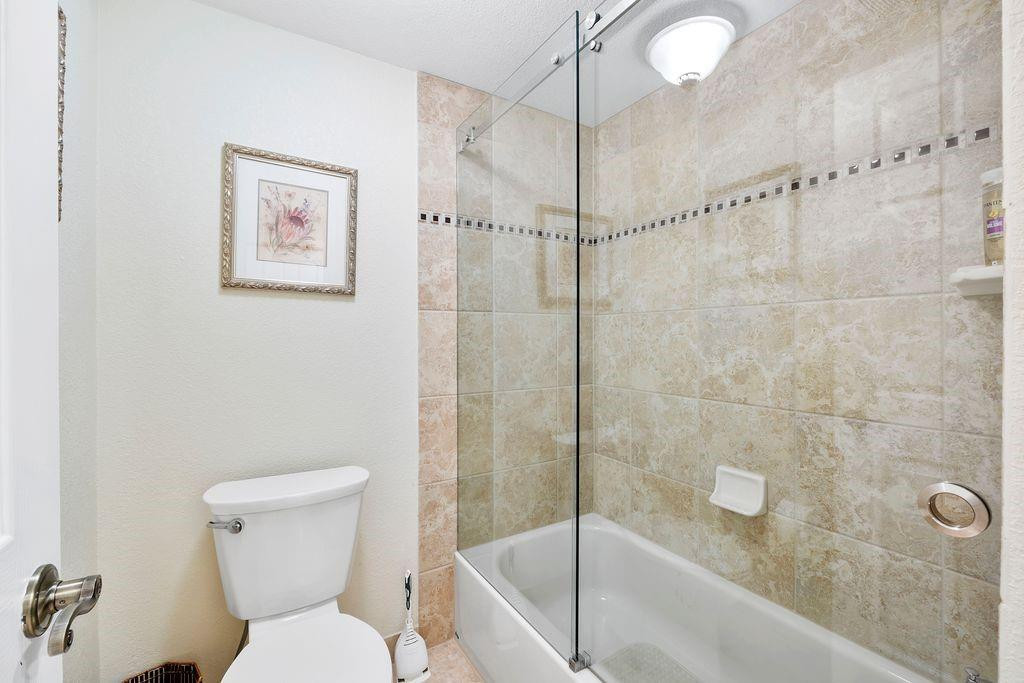21452 Juego Circle, Unit 31A Boca Raton, FL 33433 - Photo 24 of 38 a bathroom with a toilet and a shower