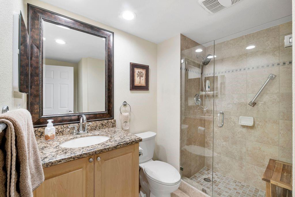 21452 Juego Circle, Unit 31A Boca Raton, FL 33433 - Photo 27 of 38 a bathroom with a granite countertop sink a toilet a shower and a mirror