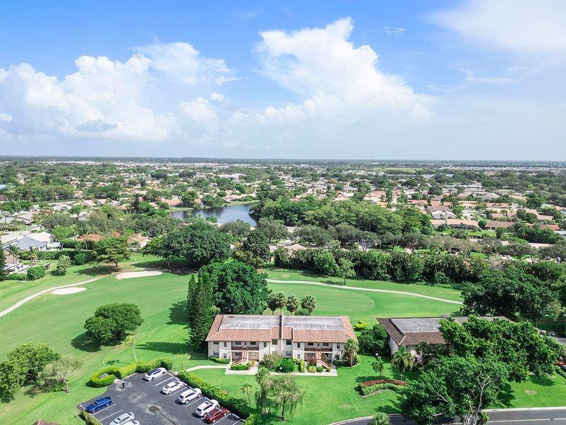 21452 Juego Circle, Unit 31A Boca Raton, FL 33433 - Photo 32 of 38 an aerial view of a golf course with parking space