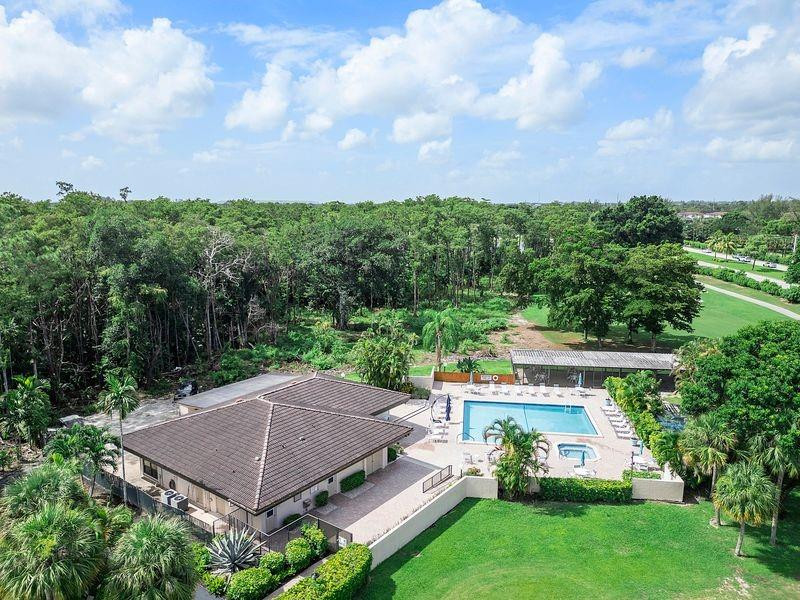 21452 Juego Circle, Unit 31A Boca Raton, FL 33433 - Photo 33 of 38 an aerial view of a house with swimming pool and garden in the back