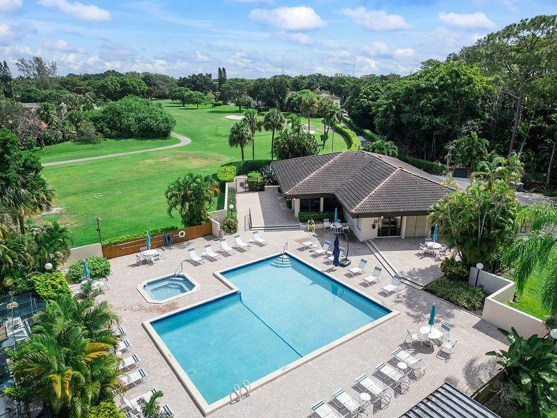 21452 Juego Circle, Unit 31A Boca Raton, FL 33433 - Photo 34 of 38 a view of a house with pool and chairs