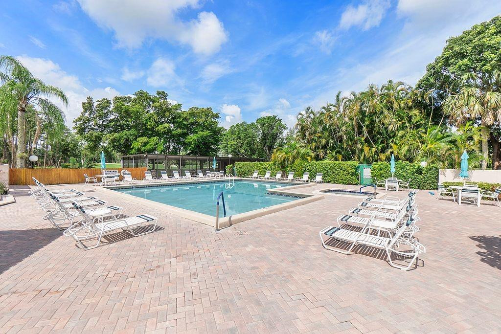 21452 Juego Circle, Unit 31A Boca Raton, FL 33433 - Photo 36 of 38 a view of a park with swings and slides