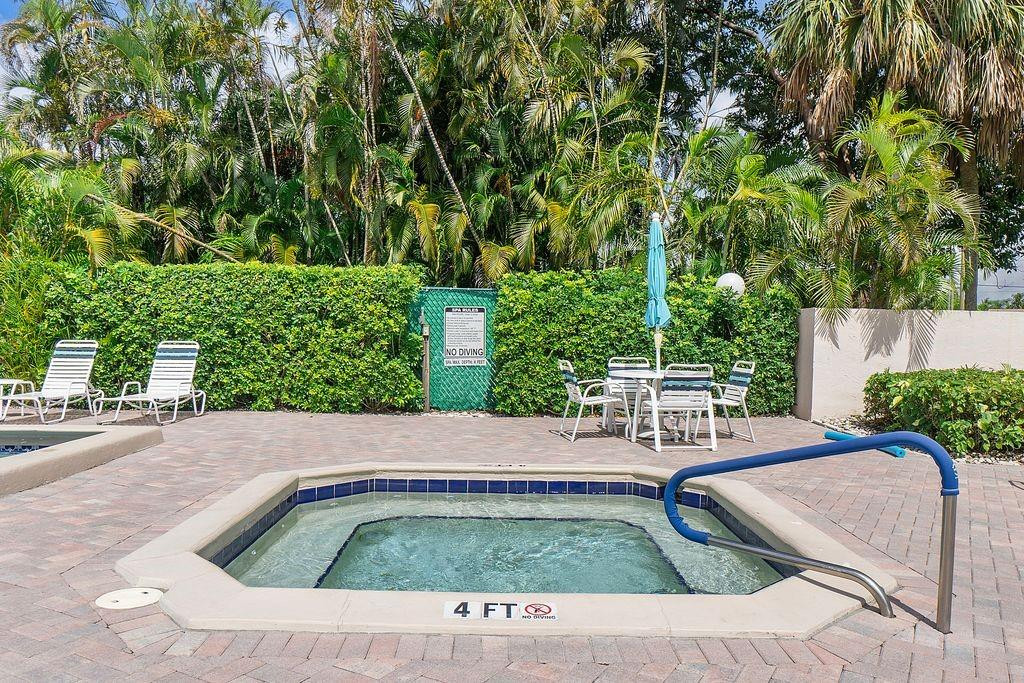 21452 Juego Circle, Unit 31A Boca Raton, FL 33433 - Photo 37 of 38 a view of backyard with swimming pool and outdoor seating