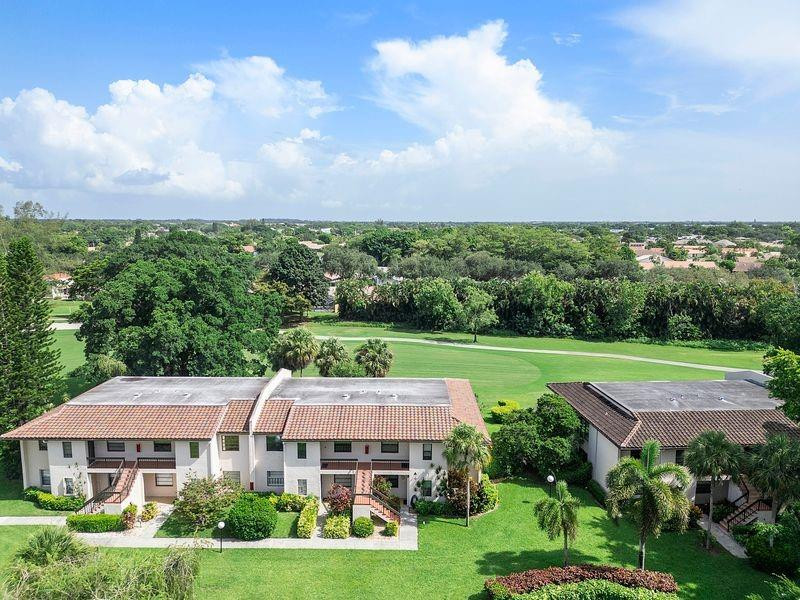 21452 Juego Circle, Unit 31A Boca Raton, FL 33433 - Photo 4 of 38 an aerial view of a house with garden space and street view